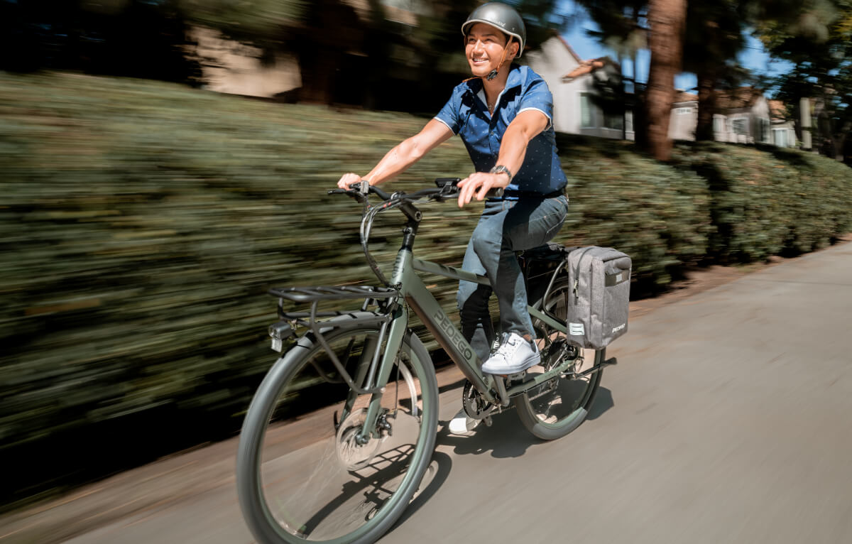 A man riding his pedego e-bike and smiling